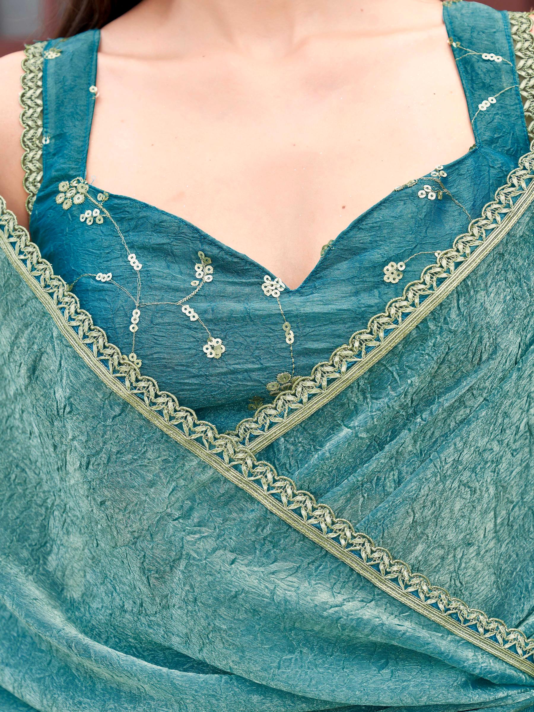 Two toned blue and gold colored wrinkled saree with embroidered blouse and embellished lace